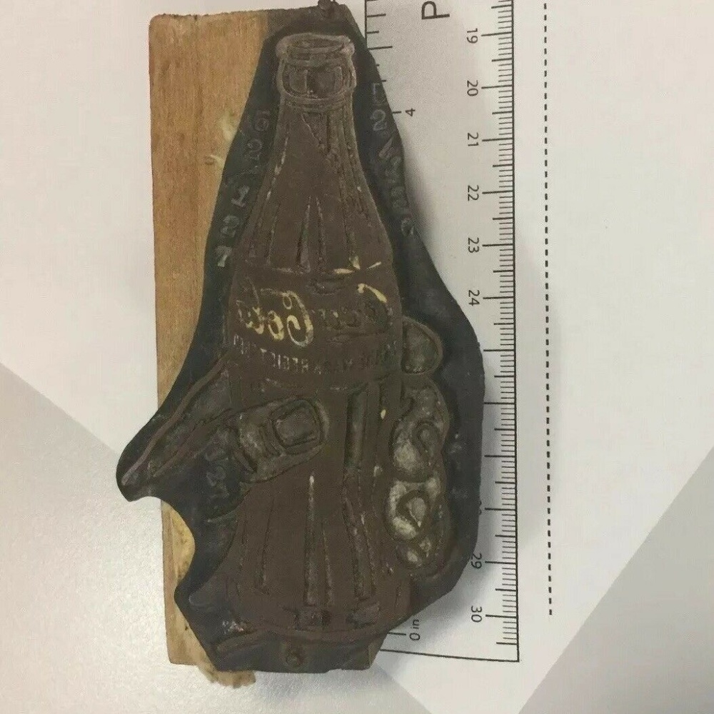 Coca Cola, Hand Holding Hobble-Skirt Bottle Letter